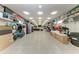 The spacious garage is equipped with storage shelves, office area, laundry and epoxy flooring at 613 6Th E Ave, Bradenton, FL 34208