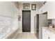 Efficient kitchenette with stainless steel appliances, white cabinetry, and granite countertops, perfect for a cozy living space at 613 6Th E Ave, Bradenton, FL 34208
