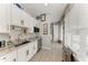 Bright kitchenette featuring white cabinets, granite counters, and a stainless sink at 613 6Th E Ave, Bradenton, FL 34208