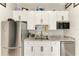 A practical kitchenette with stainless steel appliances, granite countertops, and white cabinets offers convenience at 613 6Th E Ave, Bradenton, FL 34208