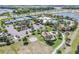 Aerial view of a community center featuring tennis courts, a playground, a pool, and ample parking surrounded by green space at 6227 Golden Nettle Dr, Apollo Beach, FL 33572