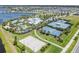 High angle view of community amenities, including a volleyball court, tennis courts, and swimming pool at 6227 Golden Nettle Dr, Apollo Beach, FL 33572