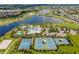 A scenic aerial view of a Primary planned community, boasting a lake, clubhouse, pools, and sports courts at 6227 Golden Nettle Dr, Apollo Beach, FL 33572