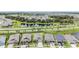 Aerial view of a community with lush landscaping, a serene pond, and well-maintained homes in a desirable location at 6227 Golden Nettle Dr, Apollo Beach, FL 33572