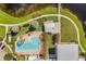 An aerial view of a community pool and clubhouse area with a relaxing pool, lounge chairs, and meticulously kept landscaping at 6227 Golden Nettle Dr, Apollo Beach, FL 33572