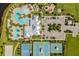 Birds eye view of community clubhouse with pool, playground, and sports courts surrounded by lush greenery at 6227 Golden Nettle Dr, Apollo Beach, FL 33572