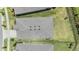An aerial view of a well-maintained roof with six skylights, surrounded by lush green lawns and mature landscaping at 6227 Golden Nettle Dr, Apollo Beach, FL 33572