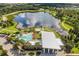 Aerial view of a community clubhouse with a pool, surrounded by a picturesque lake and well-manicured grounds at 6227 Golden Nettle Dr, Apollo Beach, FL 33572