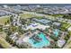 Aerial view showcases the neighborhood's tennis courts and pool, all within a well-maintained residential area at 6227 Golden Nettle Dr, Apollo Beach, FL 33572