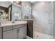 Modern bathroom with a glass shower and vanity sink with gray cabinets at 6227 Golden Nettle Dr, Apollo Beach, FL 33572