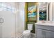 Bathroom with glass enclosed shower and matching gray vanity and framed artwork at 6227 Golden Nettle Dr, Apollo Beach, FL 33572