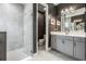 Modern bathroom with glass shower and double vanity sinks with gray cabinets at 6227 Golden Nettle Dr, Apollo Beach, FL 33572