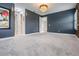 Large bedroom with gray walls, carpet, and an elegant chandelier at 6227 Golden Nettle Dr, Apollo Beach, FL 33572
