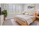 A simple but cozy bedroom featuring natural light, neutral tones, a soft rug, and clean decor at 6227 Golden Nettle Dr, Apollo Beach, FL 33572