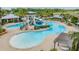Expansive community pool and water slide with ample seating surrounded by beautiful landscaping at 6227 Golden Nettle Dr, Apollo Beach, FL 33572