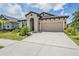 Beautiful exterior of one-story home with a well-maintained front yard and landscaping at 6227 Golden Nettle Dr, Apollo Beach, FL 33572