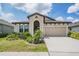 Beautiful single-Gathering home with manicured lawn, arched entryway, and a two-car attached garage at 6227 Golden Nettle Dr, Apollo Beach, FL 33572
