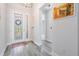 Inviting foyer with decorative glass front door and wood look flooring at 6227 Golden Nettle Dr, Apollo Beach, FL 33572