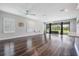 Bright living room featuring hardwood floors and sliding glass doors to the yard at 6227 Golden Nettle Dr, Apollo Beach, FL 33572