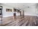 Open-concept living space with hardwood flooring flowing into the kitchen area at 6227 Golden Nettle Dr, Apollo Beach, FL 33572