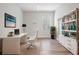 An office with a modern desk and chair, a bookshelf, and a large window at 6227 Golden Nettle Dr, Apollo Beach, FL 33572