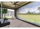 Covered patio features a ceiling fan and roll down shades with a view of the green lawn at 6227 Golden Nettle Dr, Apollo Beach, FL 33572