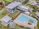 Aerial view of a community pool and clubhouse, featuring a lap pool, lounge chairs, and well-manicured landscaping at 6227 Golden Nettle Dr, Apollo Beach, FL 33572