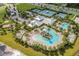 Aerial view of community center with pools, slides, tennis and basketball courts surrounded by lush landscaping at 6227 Golden Nettle Dr, Apollo Beach, FL 33572