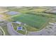 Aerial shot of a large sports field marked for soccer and football, with surrounding parking and green space at 6227 Golden Nettle Dr, Apollo Beach, FL 33572