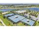 Overhead shot of community tennis courts and pool near a lake surrounded by beautiful homes at 6227 Golden Nettle Dr, Apollo Beach, FL 33572