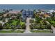 An aerial perspective showcases the home’s prime waterfront location, surrounded by lush landscaping and neighboring estates at 6526 Surfside Blvd, Apollo Beach, FL 33572