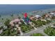 Stunning aerial view of a waterfront estate with lush landscaping and private dock, offering breathtaking coastal living at 6526 Surfside Blvd, Apollo Beach, FL 33572