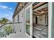 Balcony and bedroom featuring a modern tray ceiling, balcony access and scenic views at 6526 Surfside Blvd, Apollo Beach, FL 33572