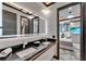 This modern bathroom includes a double sink vanity with granite countertops and views into the bedroom at 6526 Surfside Blvd, Apollo Beach, FL 33572