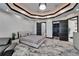 This primary bedroom includes a bed, seating area, walk-in closet, and ensuite bathroom, with white walls at 6526 Surfside Blvd, Apollo Beach, FL 33572