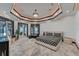 This bedroom features a geometric design, chandelier, and an adjacent balcony with beautiful water views at 6526 Surfside Blvd, Apollo Beach, FL 33572