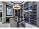 Custom walk-in closet with stylish lighting, island storage, mirrored cabinets and ample hanging space at 6526 Surfside Blvd, Apollo Beach, FL 33572