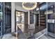 Bright walk-in closet featuring an island, chandelier, and custom storage at 6526 Surfside Blvd, Apollo Beach, FL 33572