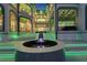 Elegant courtyard with a decorative fountain and stunning architectural details, enhanced by vibrant green accent lighting at 6526 Surfside Blvd, Apollo Beach, FL 33572