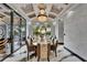Formal dining room features a large table and seating under an elegant chandelier at 6526 Surfside Blvd, Apollo Beach, FL 33572
