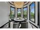 Bright dining room with large windows and seating for seven around a marble table at 6526 Surfside Blvd, Apollo Beach, FL 33572