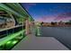 Modern dock with boat lift, green lighting, and stunning views of waterfront homes at 6526 Surfside Blvd, Apollo Beach, FL 33572