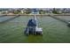 An aerial shot of the boat dock features a lift system and views of the intercoastal waterway at 6526 Surfside Blvd, Apollo Beach, FL 33572