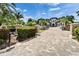 A brick driveway and landscaping welcome you to this luxury waterfront home at 6526 Surfside Blvd, Apollo Beach, FL 33572