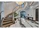 Grand foyer with a curved staircase, statement lighting, and elegant entryway at 6526 Surfside Blvd, Apollo Beach, FL 33572