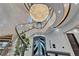 Elegant foyer featuring a spiral staircase, a grand chandelier, and doors leading to the outside at 6526 Surfside Blvd, Apollo Beach, FL 33572
