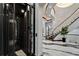 Modern foyer featuring an elevator, marble floors, and a staircase leading to the upper level at 6526 Surfside Blvd, Apollo Beach, FL 33572