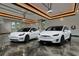 Spacious garage featuring modern lighting and ample parking space for two Tesla vehicles at 6526 Surfside Blvd, Apollo Beach, FL 33572