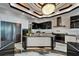 Contemporary kitchen featuring white cabinetry, black countertops, and high-end stainless-steel appliances at 6526 Surfside Blvd, Apollo Beach, FL 33572