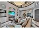 Open-concept living room featuring a fireplace, staircase, and high ceilings with a grand chandelier at 6526 Surfside Blvd, Apollo Beach, FL 33572
